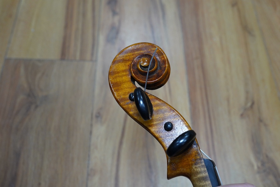 A cased early 20th century European violin, with label reading ‘Antonius Stradivarius Cremonenfis’, body length 36cm, with P&H London bow. Condition - good